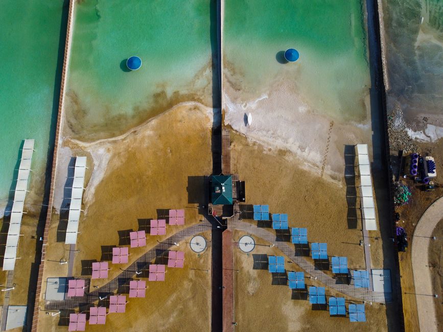 People floating in the mineral-rich waters of a public beach at Ein Bokek, Dead Sea, Israel