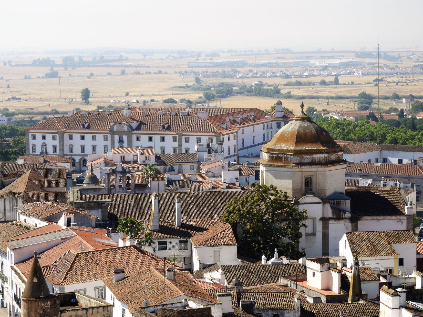 Aerial shot of the picturesque historic town of Evora, Portugal, featuring traditional architecture. — photo by Magali Guimarães / Pexels
