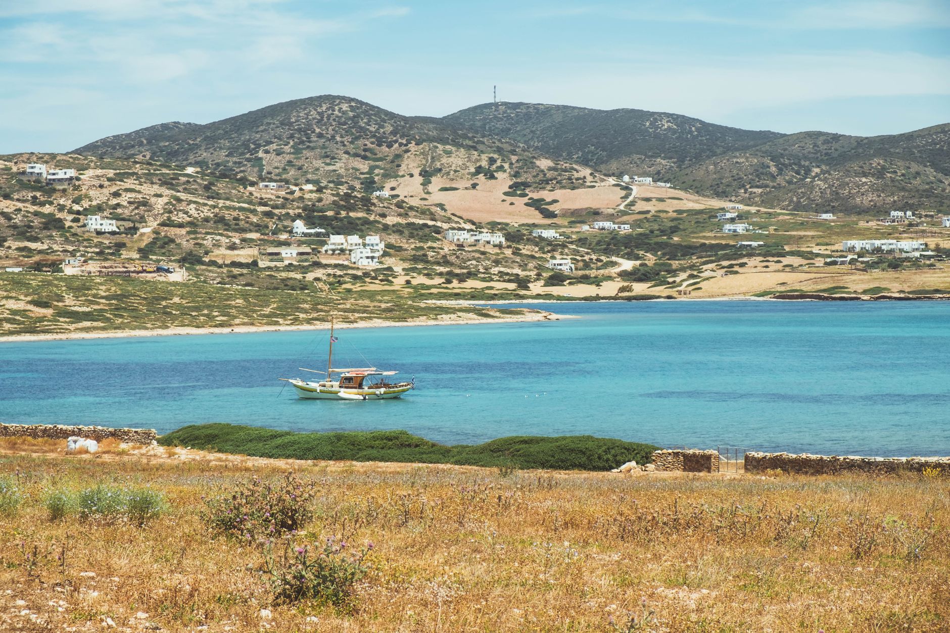 Scenic view of a boat on the clear blue waters of Paros, Greece.