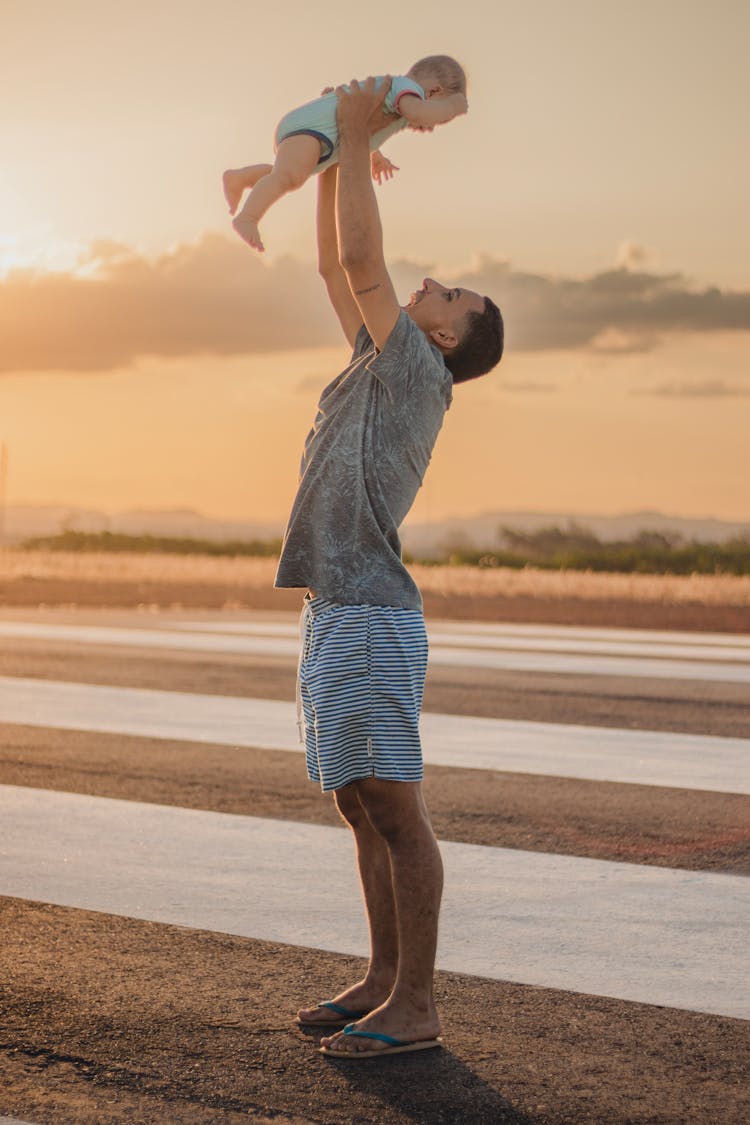 A Father Lifting His Child