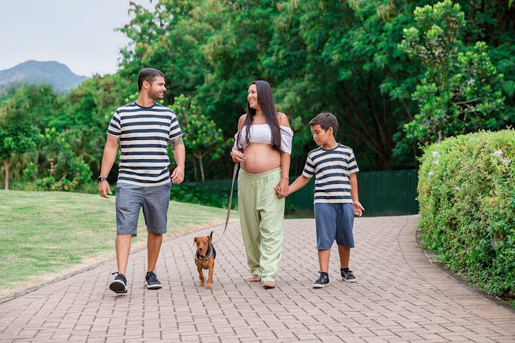 Family Walking With A Dog