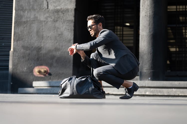 Man In Gray Suit Looking At The Time