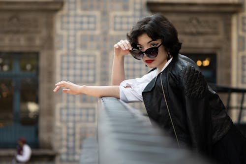 Woman in Black Leather Jacket and White Dress Shirt Wearing Black Sunglasses