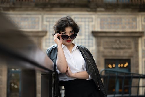 Woman in Black Leather Jacket and White Dress Shirt Wearing Black Sunglasses