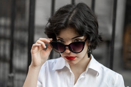 Woman in White Button Up Shirt Wearing Black Sunglasses