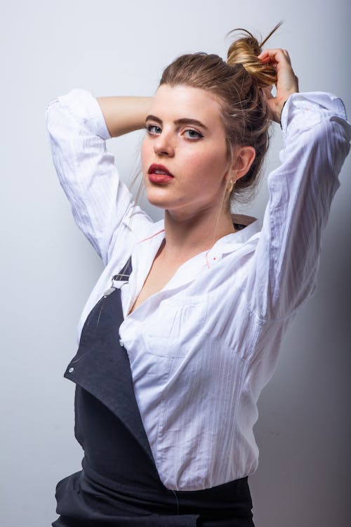 Woman Wearing White Dress Shirt Tying Her Hair