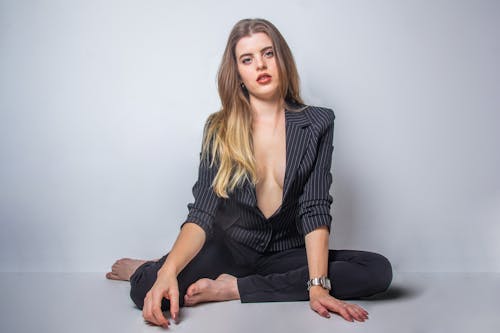 Woman in Black Blazer Sitting on Floor
