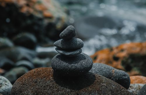Free Close-up of balanced pebbles creating a zen ambiance by the shoreline. Stock Photo