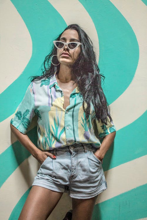 Woman in Floral Button Up Shirt Wearing Black Sunglasses