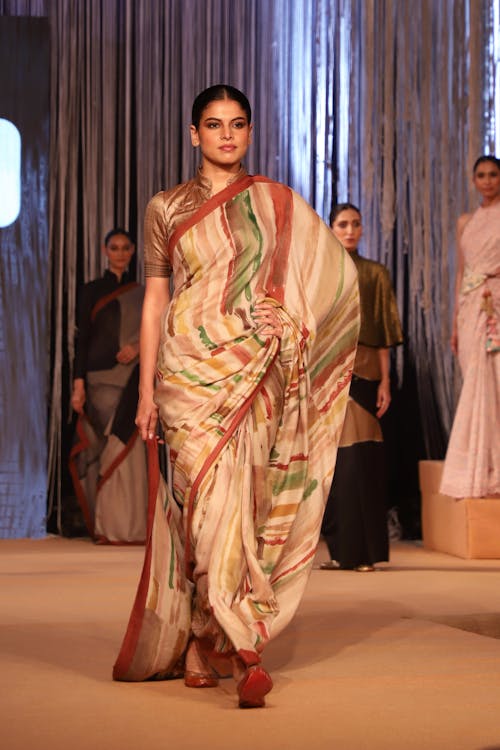 Woman in Beige and Brown Dress  Modelling on a Fashion Show