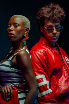 Dynamic studio portrait of fashionable models showcasing bold styles and creative makeup.