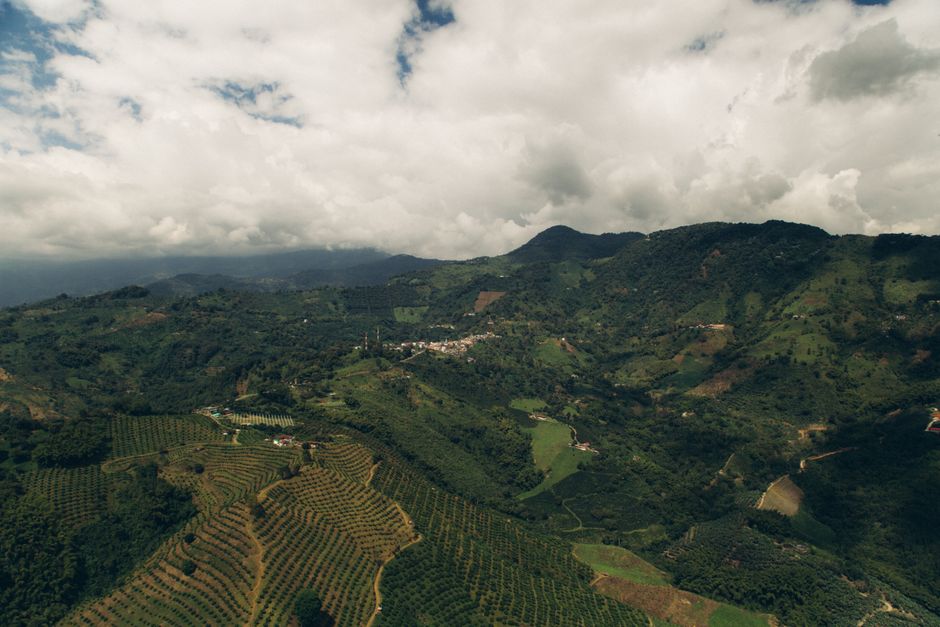 Aerial landscape of scenic mountain rice terraces under cloudy skies.