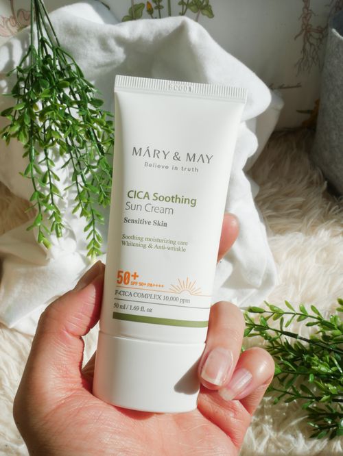 Free A detailed shot of a hand holding a CICA Soothing Sun Cream tube, ideal for skincare promotions. Stock Photo