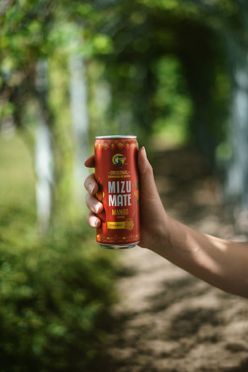 A Person Holding Soda in a Can