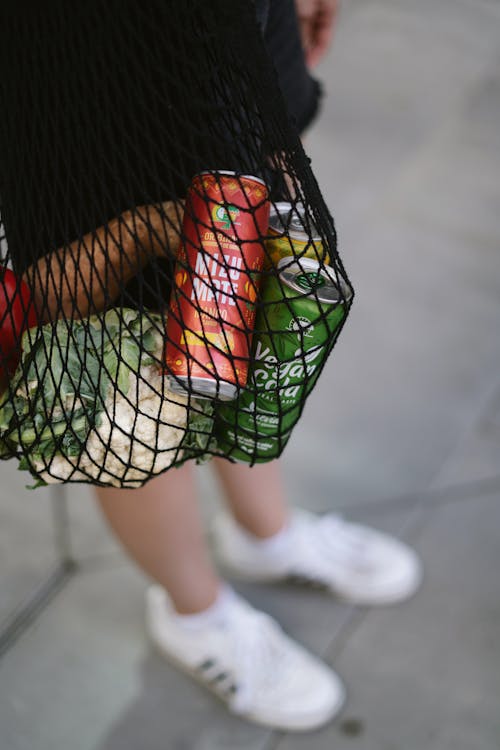 Can Sodas in a Black Mesh Bag