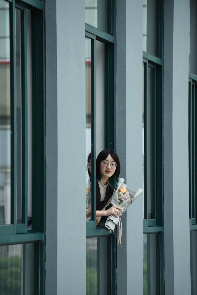 Woman With A Bouquet Leaning Through A Window