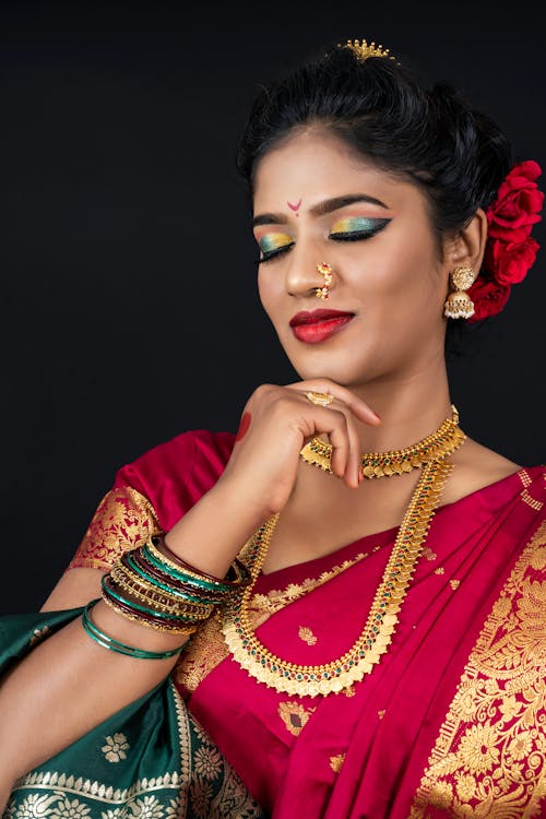 Free Woman in Red and Gold Top Wearing Gold Jewelries Stock Photo