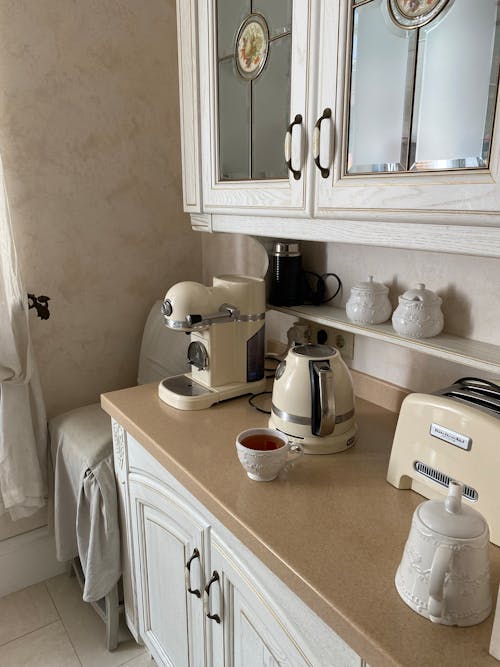 Free A Cup of Tea beside a Kettle on a Countertop Stock Photo