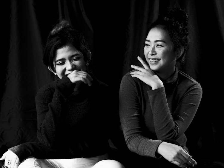 Black And White Photo Of Two Women Laughing Together