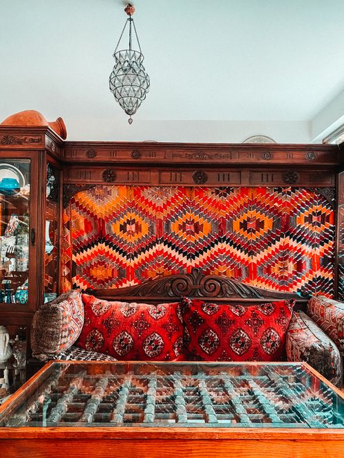Free Colorful ottoman living room with vintage furnishings and glass table featuring Turkish design. Stock Photo