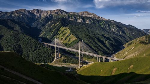 Free Scenic aerial view of the Guozigou Bridge amidst lush greenery and mountains in Xinjiang, China. Stock Photo