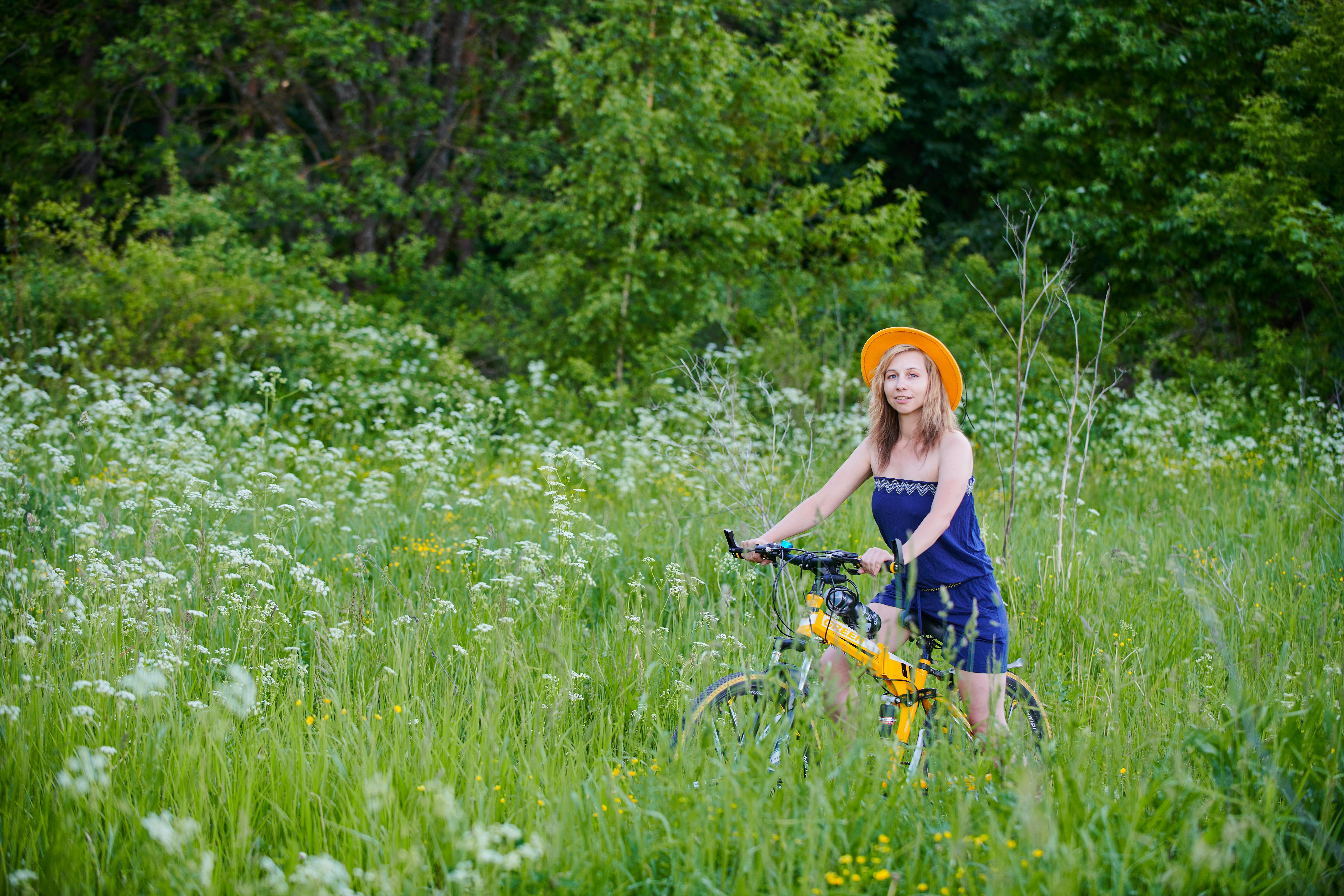 woman riding a bike on green grass