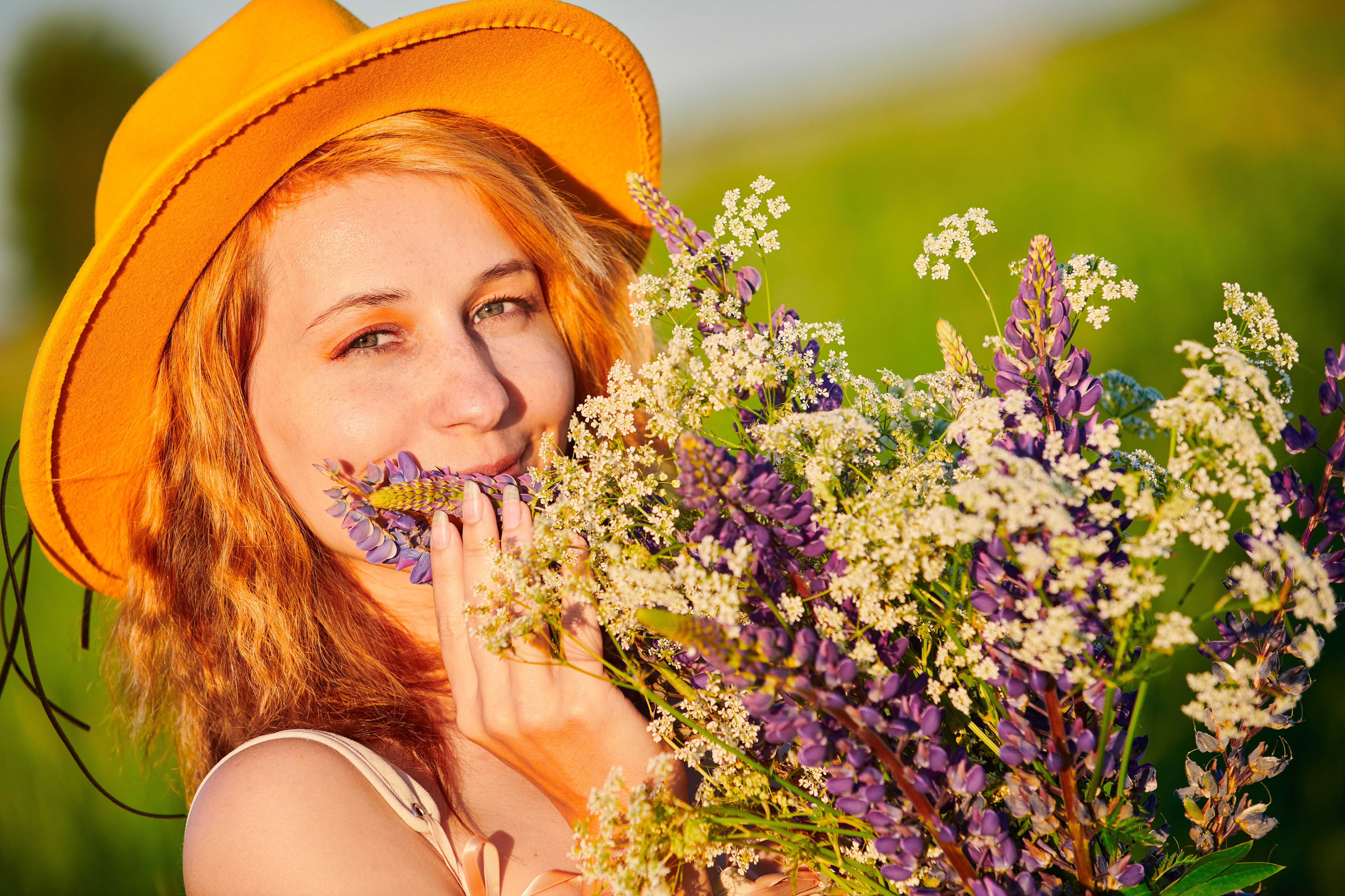 A Woman in Yellow Hat Holding a Bunch of Flowers · Free Stock Photo