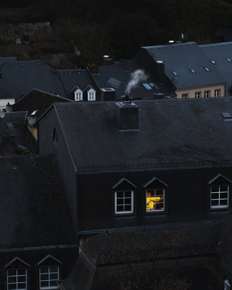 A Smoke On The Chimney Of A Concrete House