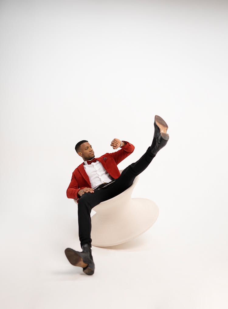 Man Sitting On Unstable Chair