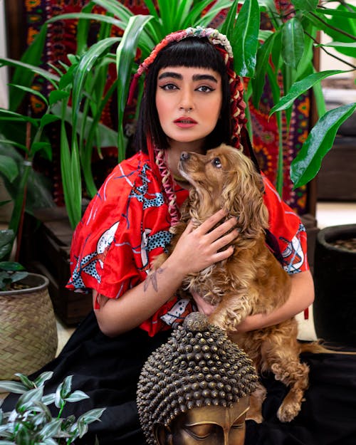 Woman Holding a Brown Dog 