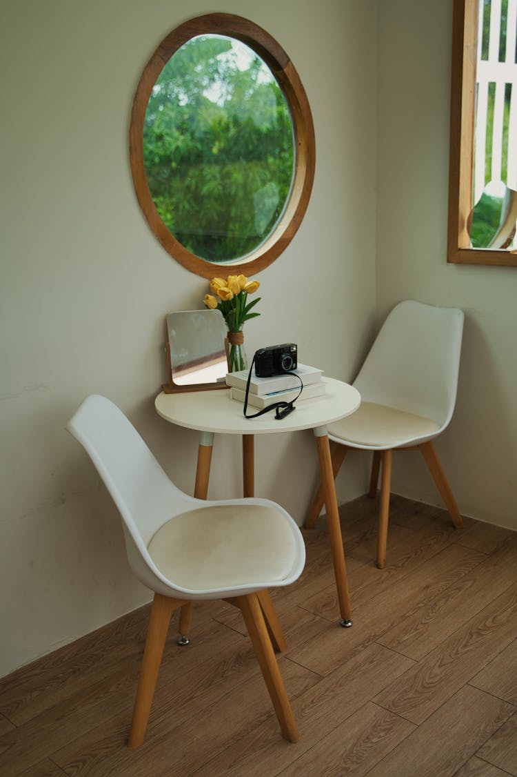 Interior With A Circular Window, A Table And Chairs