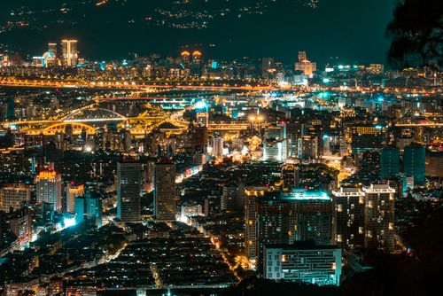 Free Captivating aerial view of a vibrant city illuminated at night, showcasing stunning architectural details. Stock Photo