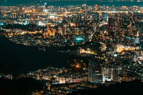 Free Stunning aerial view of a city skyline at night with illuminated skyscrapers. Stock Photo