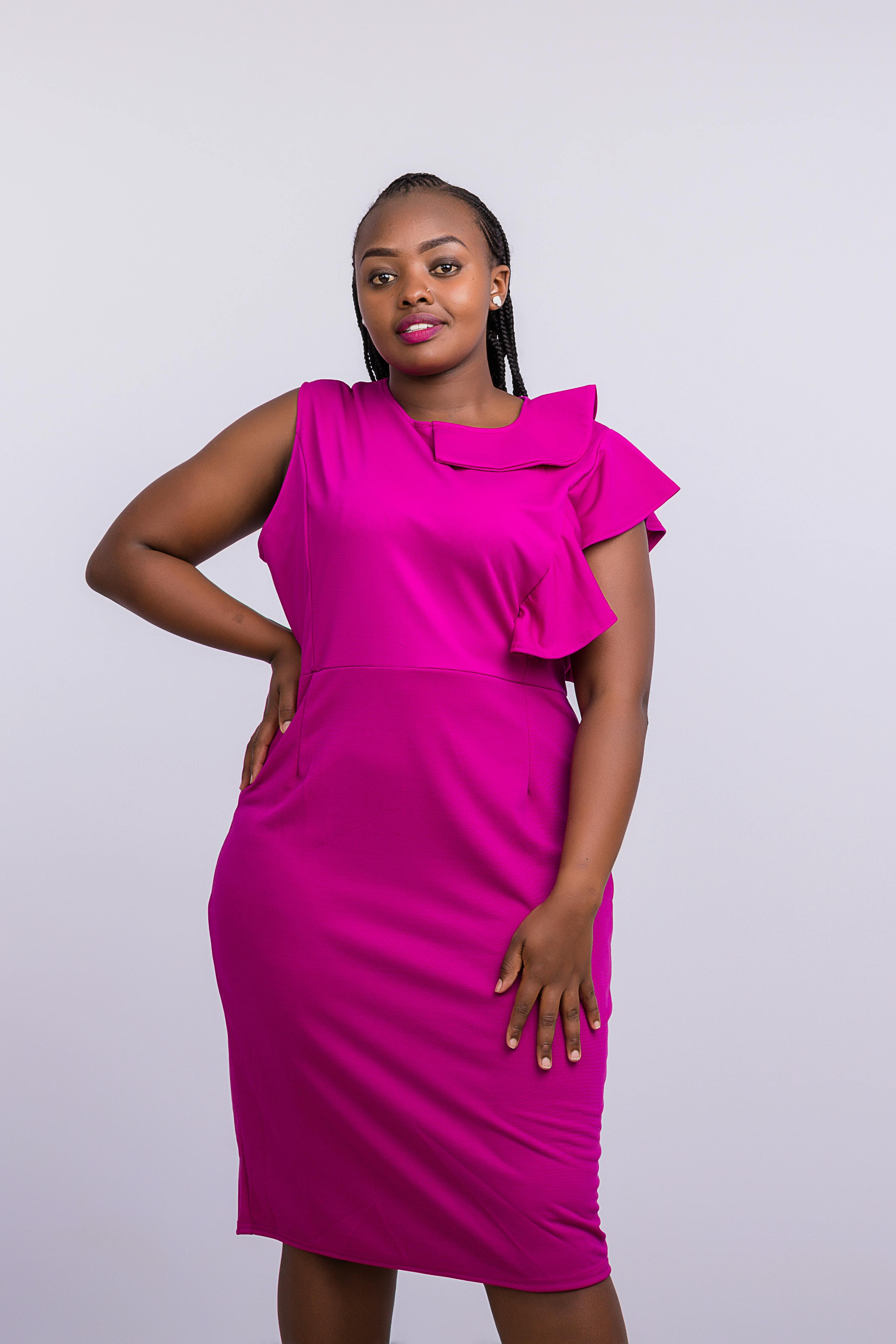 Photo of a Smiling Woman Wearing a Pink Dress with Hands on Hips · Free