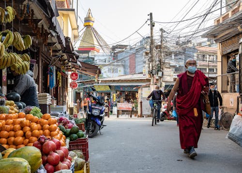 Photo of a Buddhist Monk Walking on the Sreet
