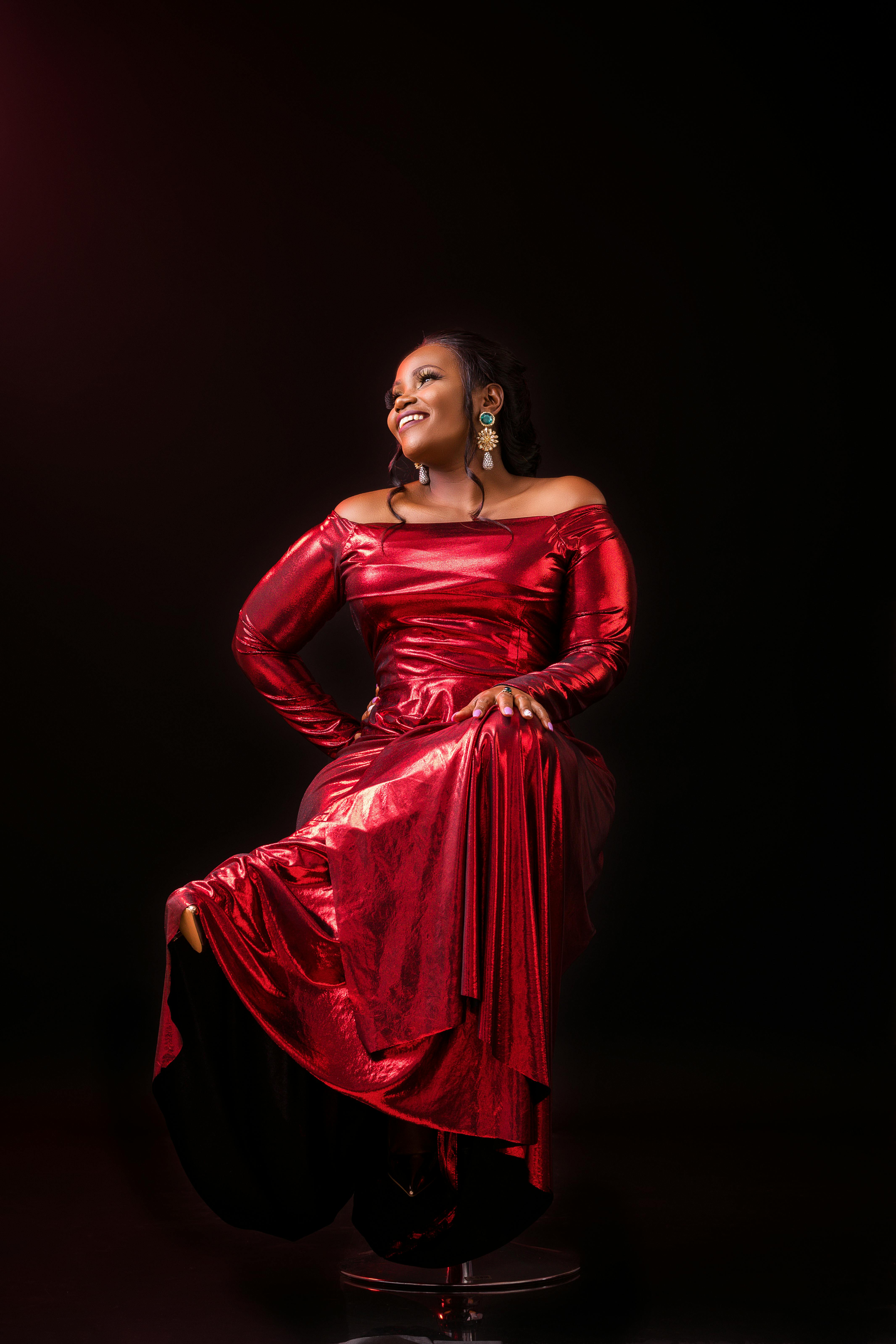 smiling woman in shiny red gown