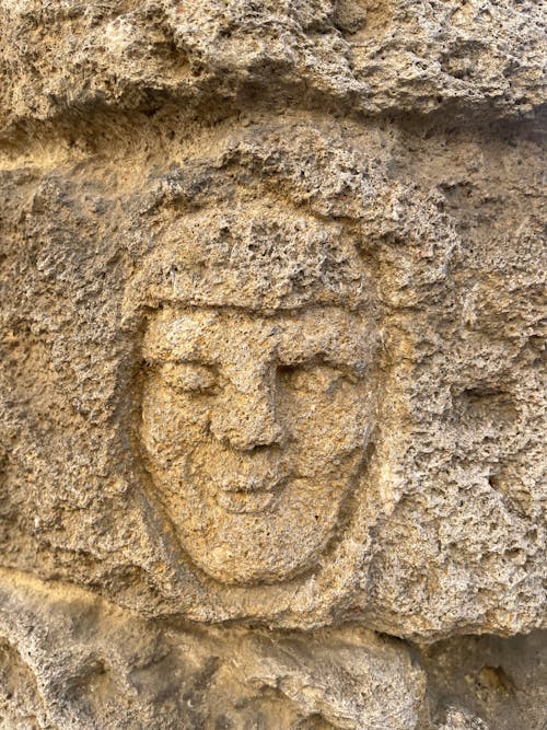 Photo of a Face Carved in the Stone