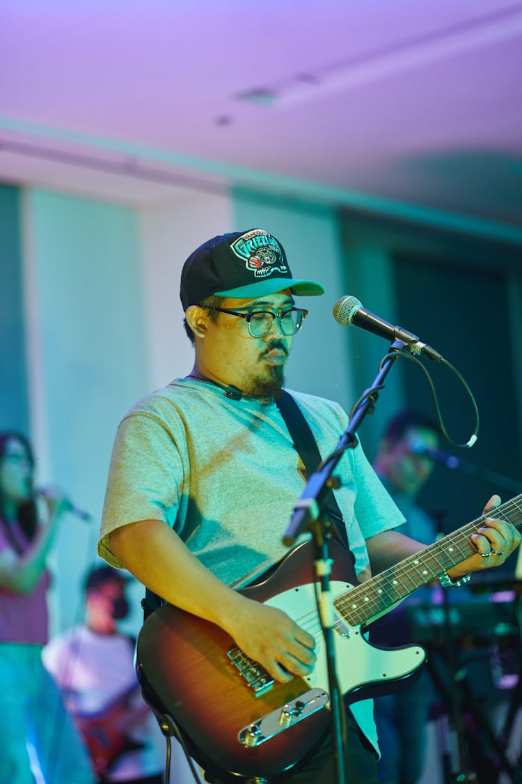 Man Playing Guitar On Stage