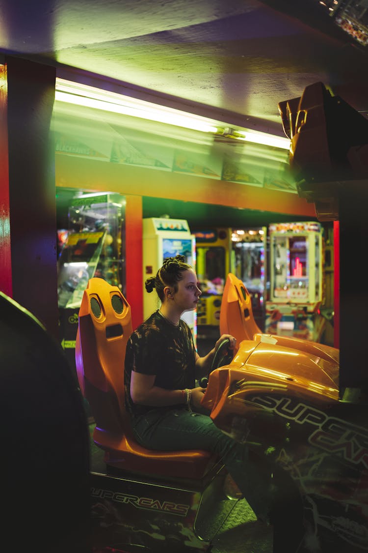 Woman Playing Driving Game In Casino