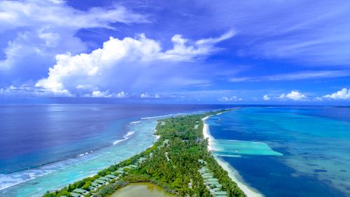 Free Discover the stunning coastline and lush greenery of Addu City, Maldives from above. Stock Photo