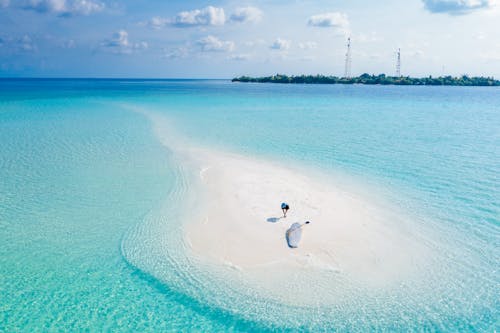 Drone Shot of a Person on a White Beach 