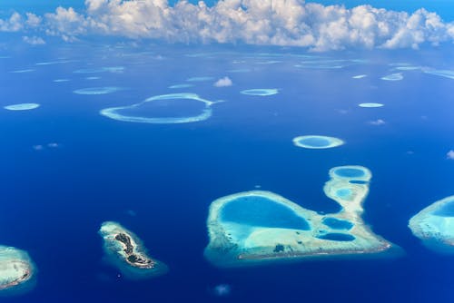 Aerial View of Blue Ocean under White Clouds