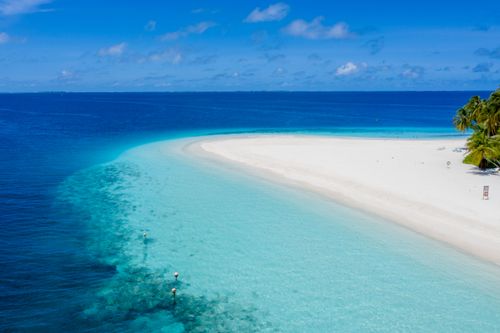 Free Aerial view of a serene tropical beach with turquoise waters in Guraidhoo, Maldives. Stock Photo