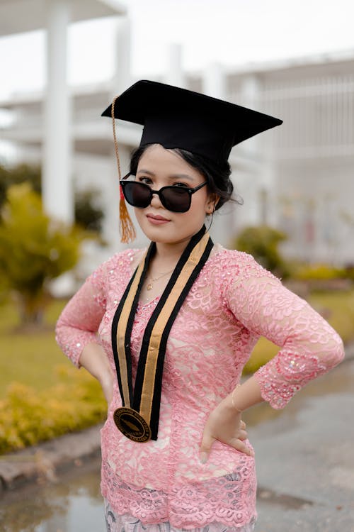 Woman in Pink Dress Wearing Graduation Cap