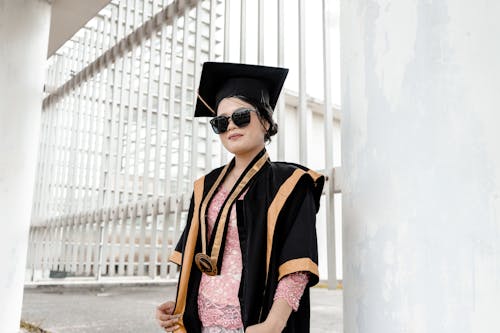 A Woman in Black Academic Hat and Pink Floral Dress