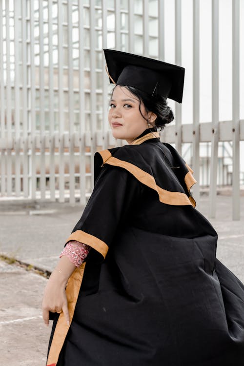 Woman Wearing Academic Dress and Graduation Cap