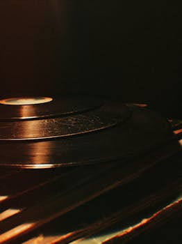 Captivating shot of vintage vinyl records stacked with warm lighting, evoking a retro vibe.