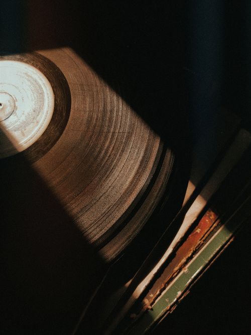 Free Vintage vinyl record captured with warm artistic lighting in Rio Vermelho, Brazil. Stock Photo