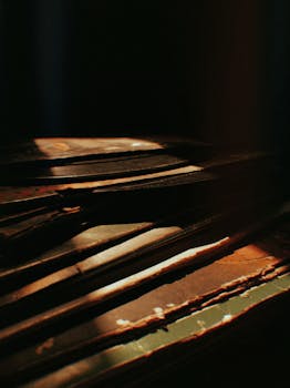 Close-up of vintage vinyl records with warm, nostalgic lighting in Rio Vermelho, Brazil.