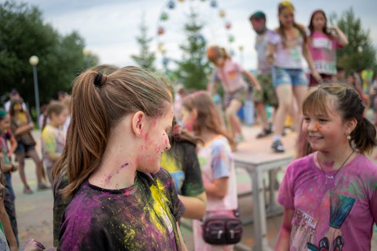 Happy Girls Covered In Paint On Summer Festival